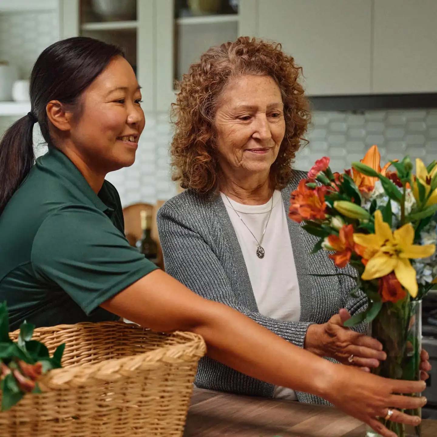 Senior and caregive smiling together